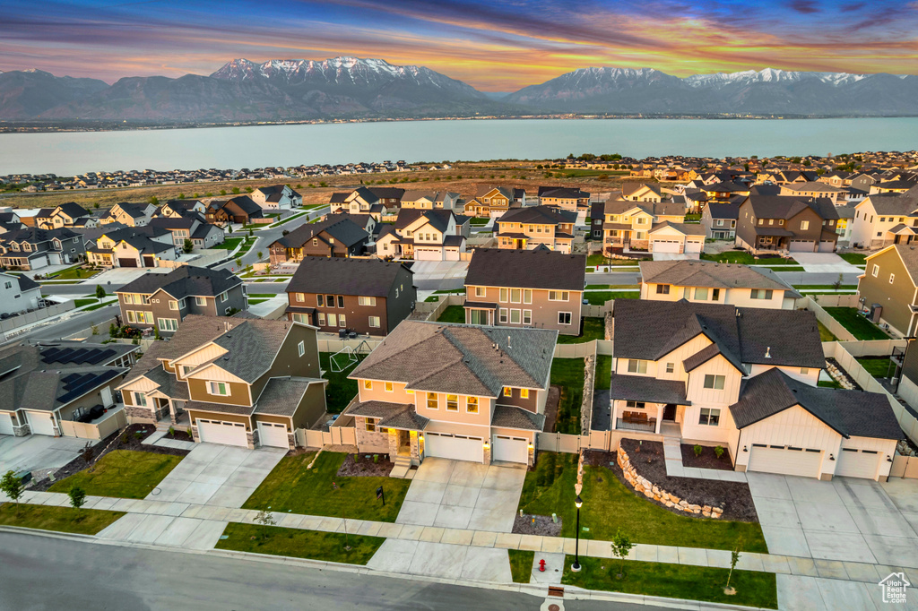 Aerial perspective of suburban area with a water and mountain view
