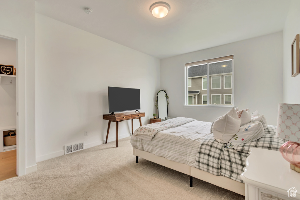 Carpeted bedroom featuring baseboards