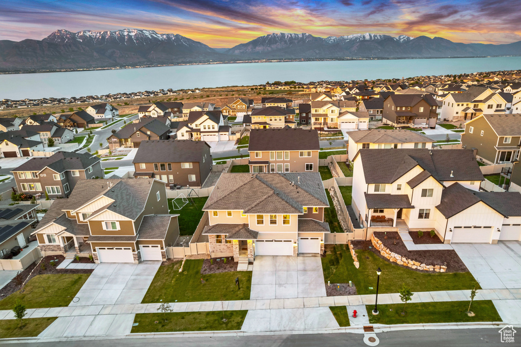 Aerial view at dusk of a residential view and a water and mountain view