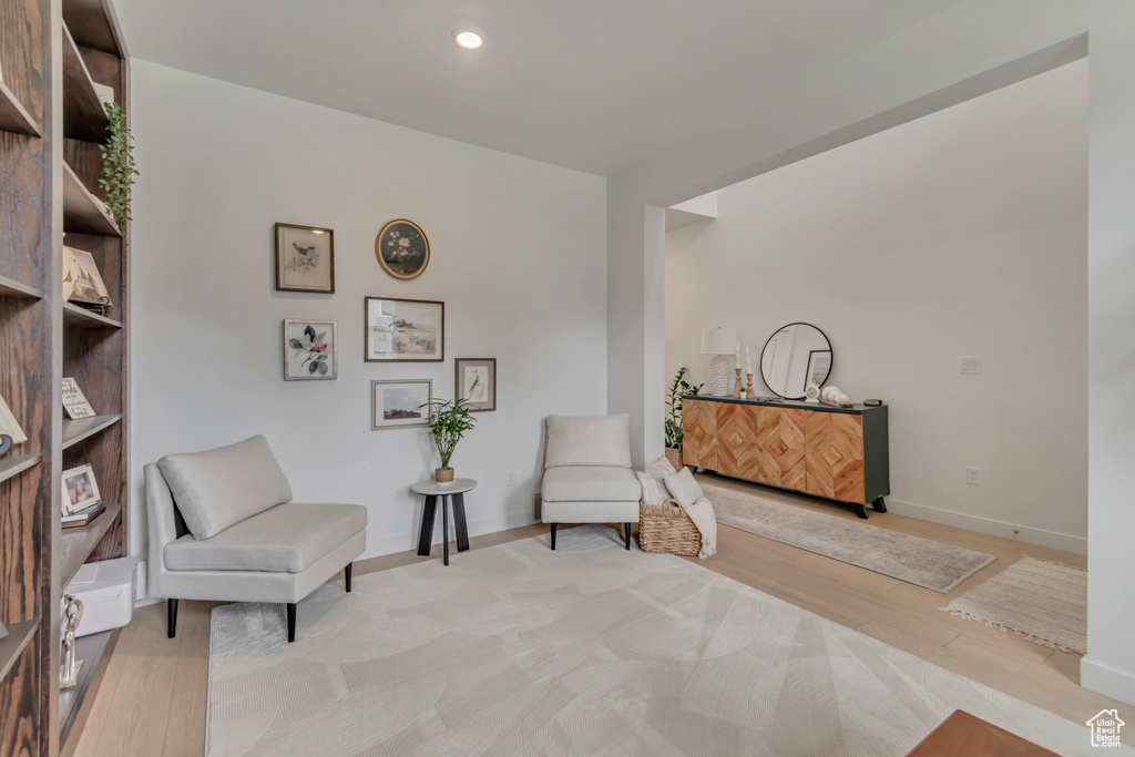 Sitting room with light wood-style flooring, baseboards, and recessed lighting