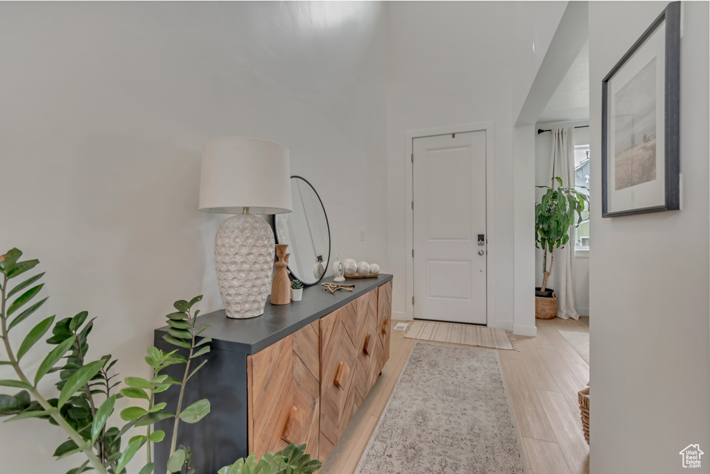 Foyer entrance featuring light wood-style floors and baseboards