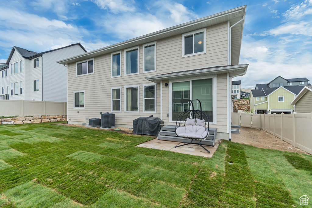 Back of property featuring central AC and a patio area