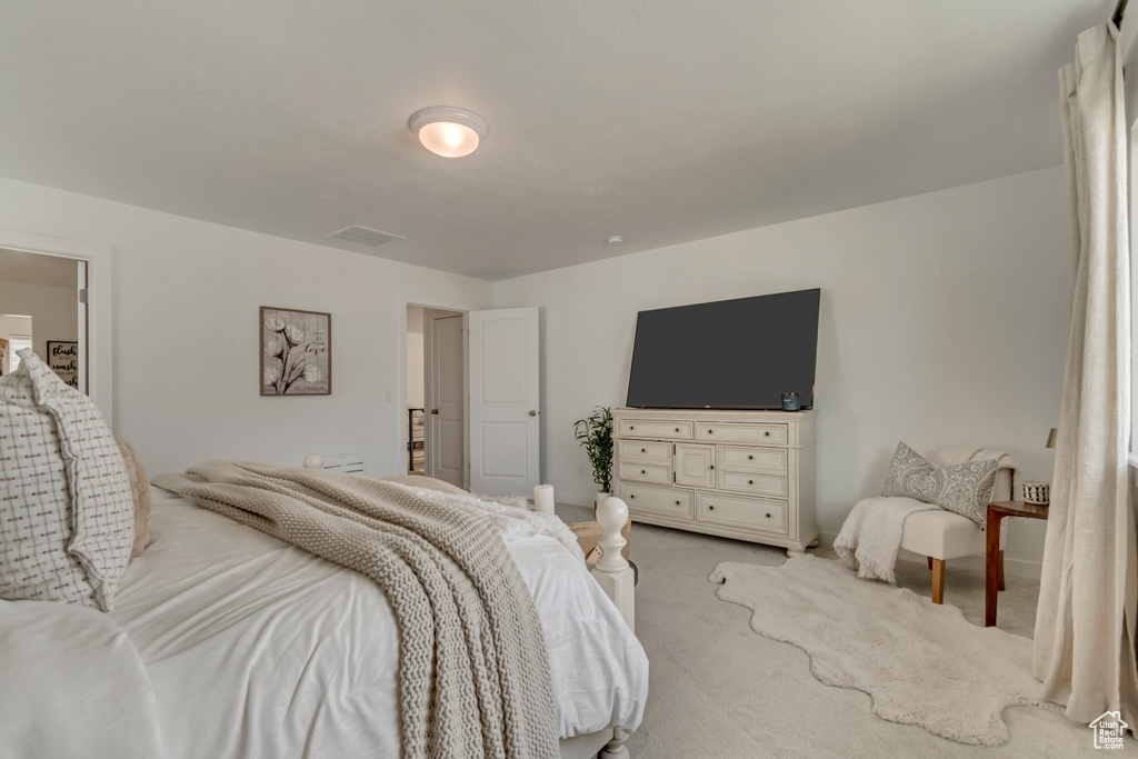 Bedroom with light carpet
