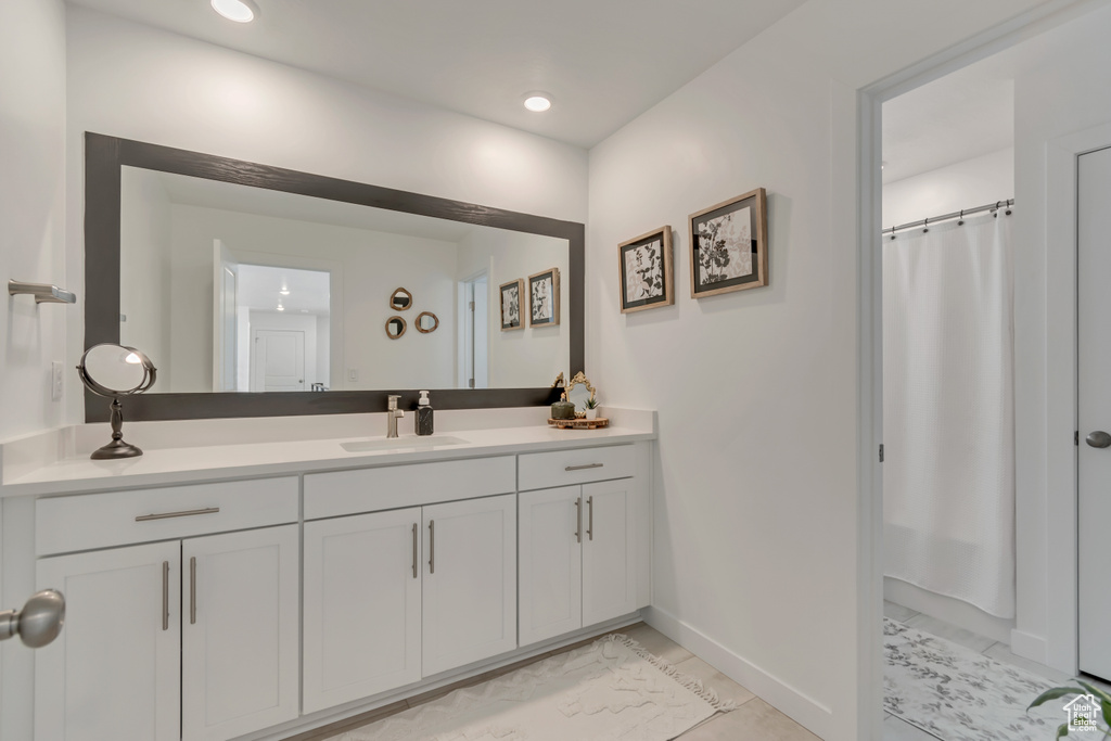 Bathroom featuring marble finish floors, baseboards, vanity, a shower with shower curtain, and recessed lighting