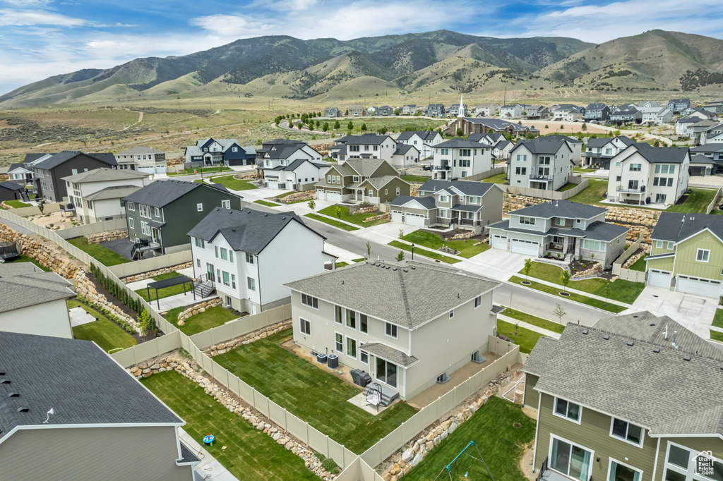Aerial perspective of suburban area featuring a mountainous background