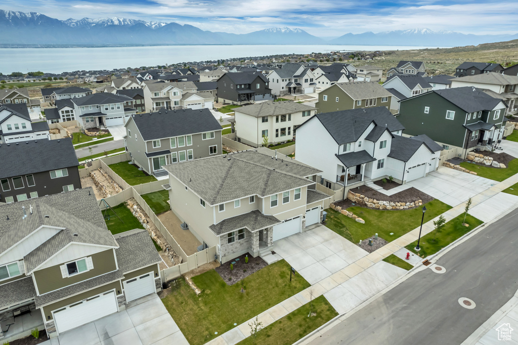 Aerial perspective of suburban area with a water and mountain view