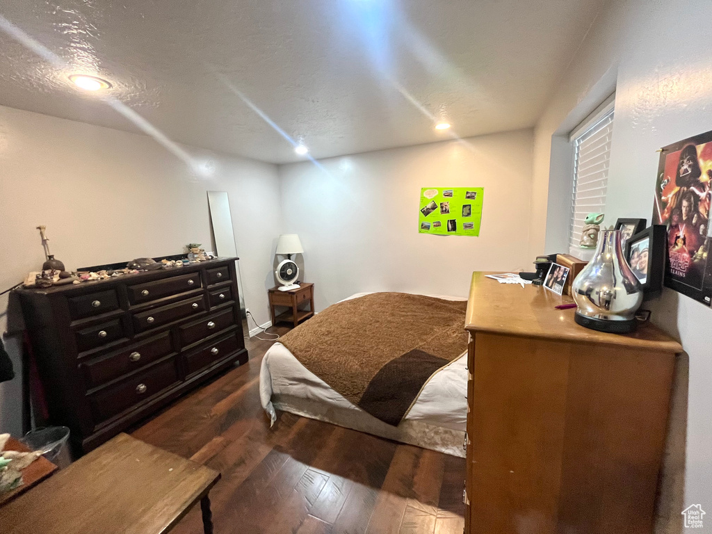 Bedroom featuring dark wood-style flooring