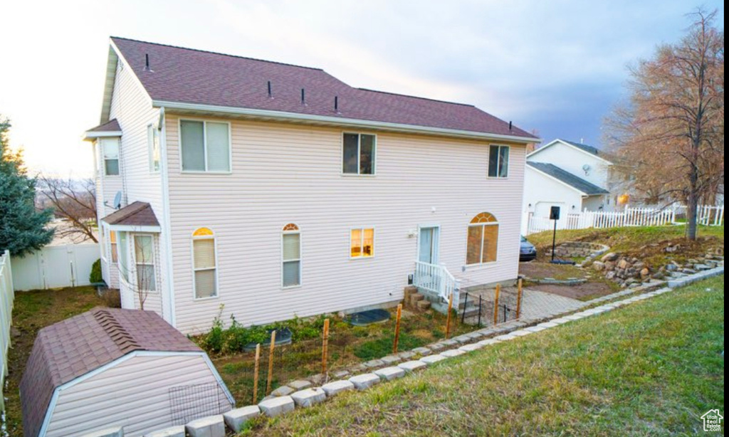 Rear view of property featuring a fenced backyard