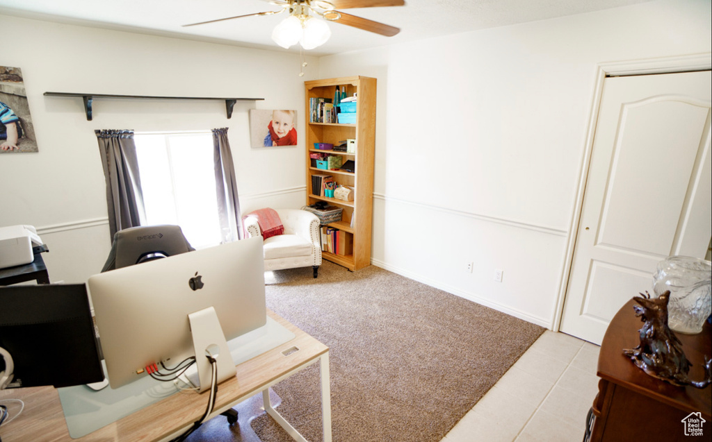 Office area with ceiling fan and tile patterned floors
