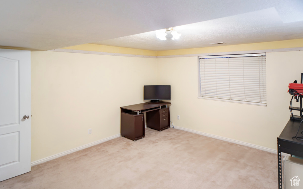 Unfurnished office with light colored carpet and baseboards