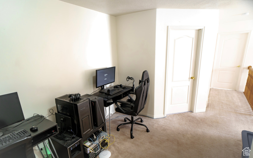 Home office featuring carpet and baseboards