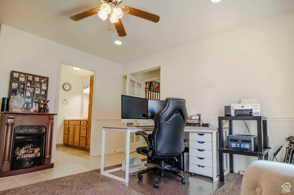 Office space featuring ceiling fan, light tile patterned floors, a fireplace, and recessed lighting