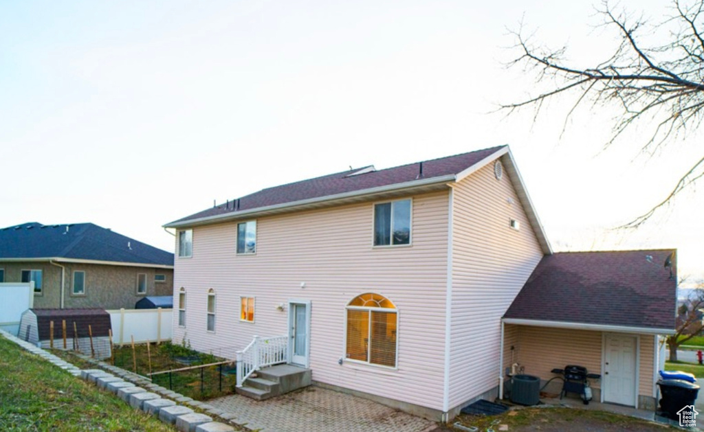 Rear view of property featuring central AC unit