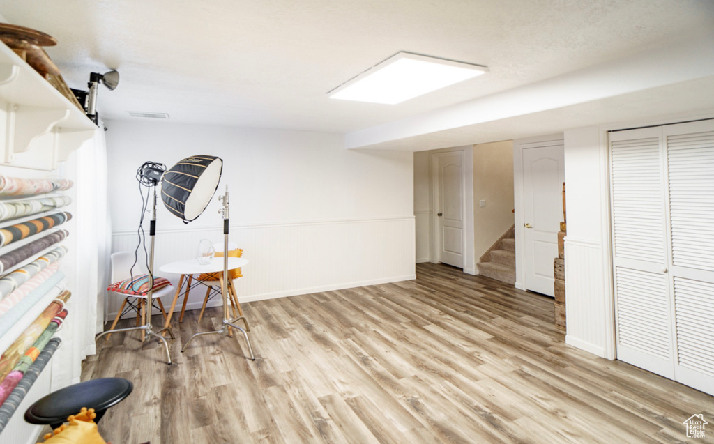 Finished below grade area with wood finished floors and stairway