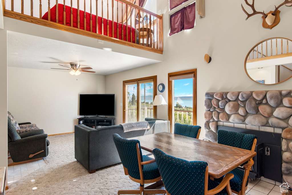 Dining room with a fireplace and ceiling fan