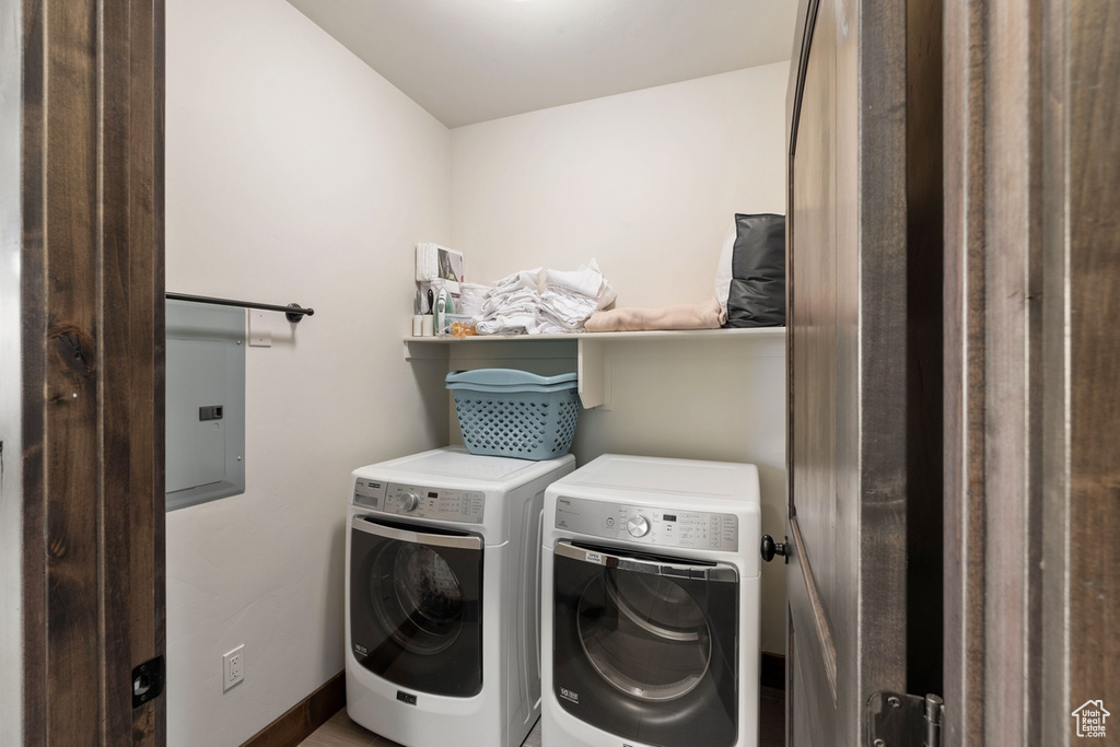 Laundry area featuring separate washer and dryer and electric panel