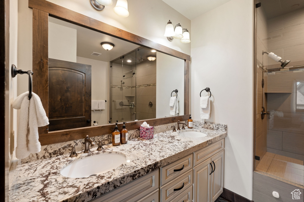 Bathroom with a stall shower and double vanity