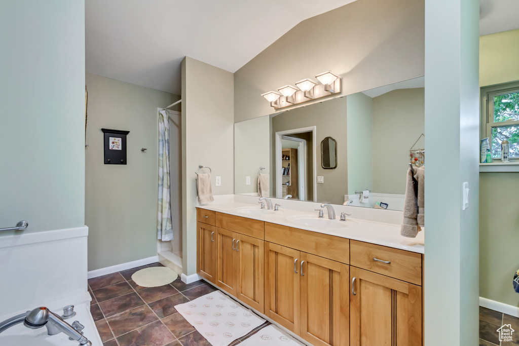 Full bathroom featuring a shower with curtain, double vanity, and baseboards