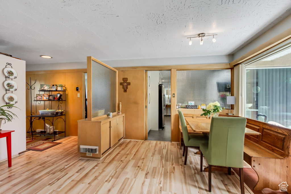 Dining area with light wood-style floors