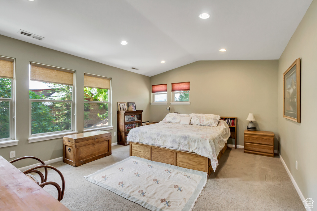 Bedroom featuring light colored carpet, vaulted ceiling, recessed lighting, and baseboards