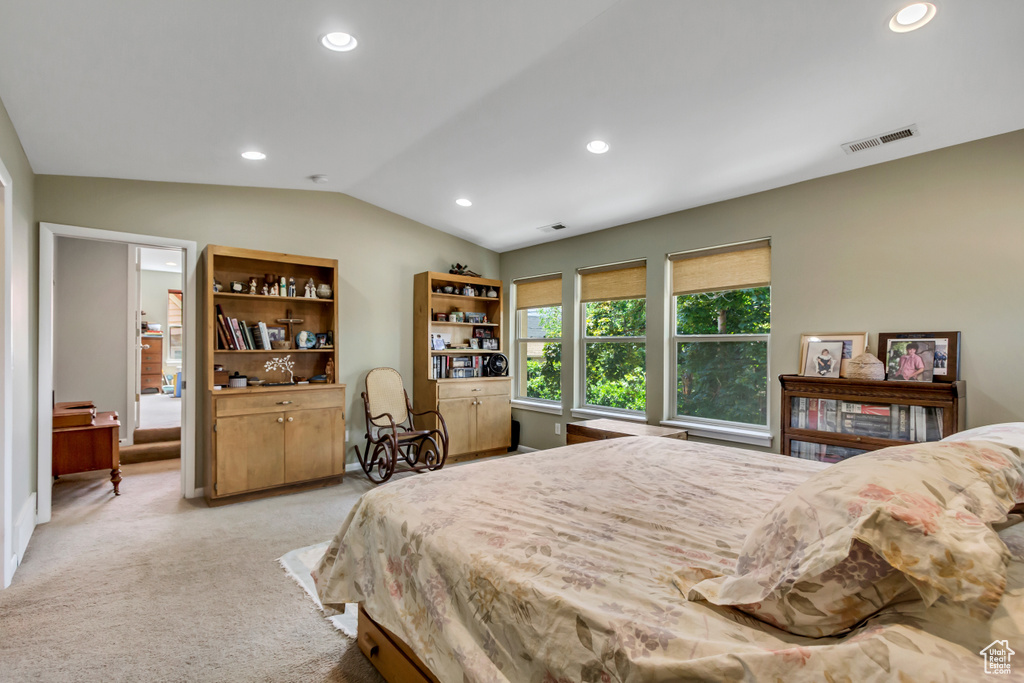 Bedroom featuring lofted ceiling, light carpet, and recessed lighting