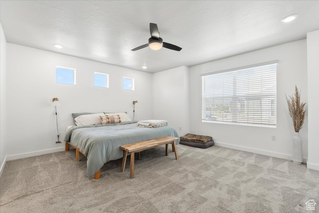 Carpeted bedroom with baseboards, a ceiling fan, and recessed lighting