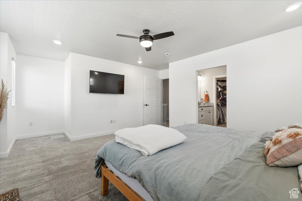 Carpeted bedroom with baseboards, a walk in closet, recessed lighting, and ceiling fan