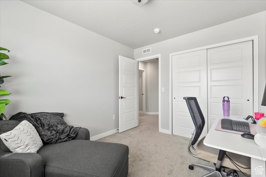 Office featuring light carpet and baseboards
