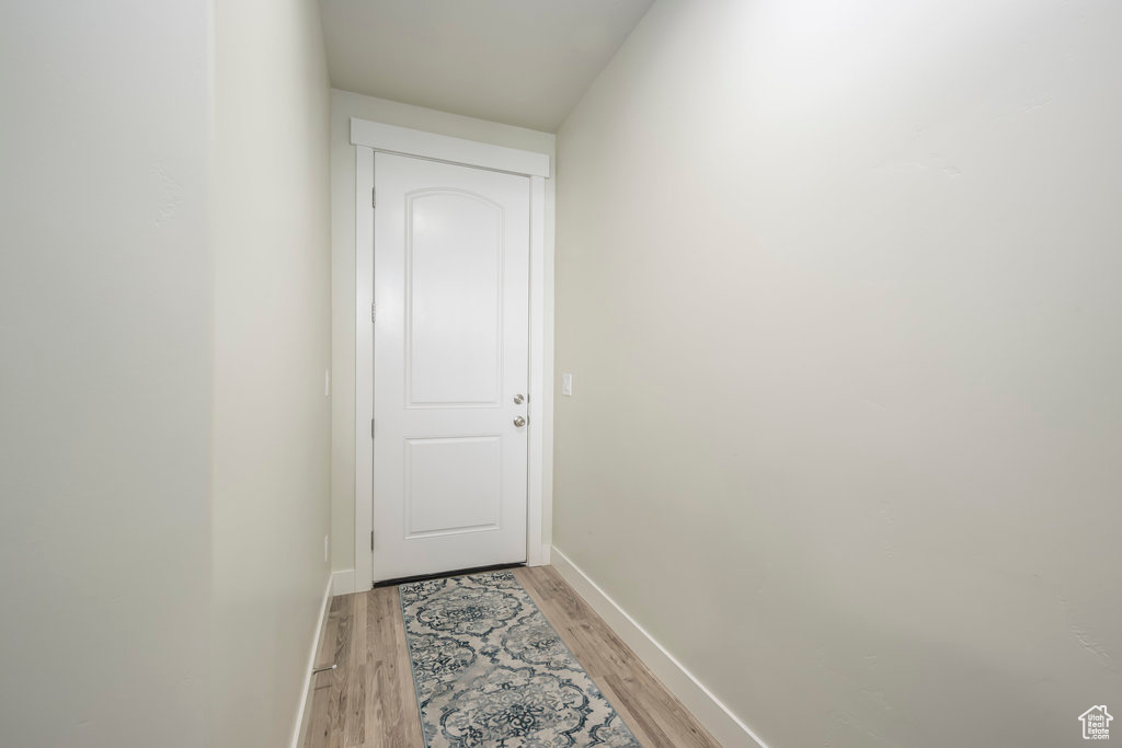 Entryway with light wood finished floors and baseboards
