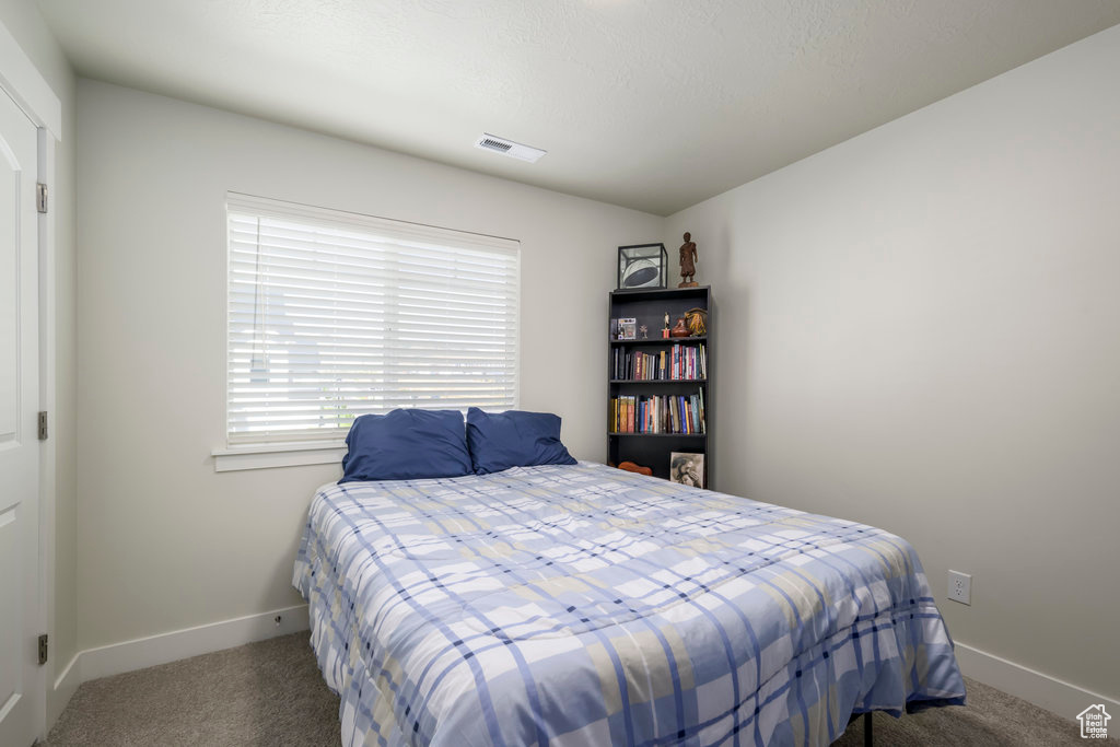 Bedroom with carpet floors and baseboards