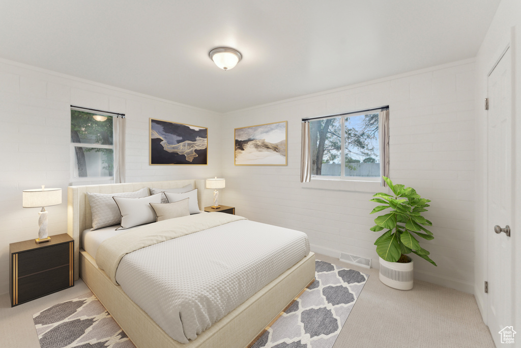 Carpeted bedroom with crown molding