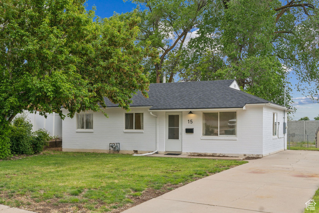 View of front of home featuring roof with shingles and concrete driveway
