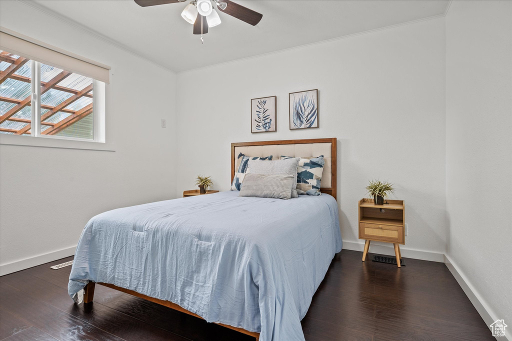 Bedroom with wood finished floors, baseboards, and ceiling fan