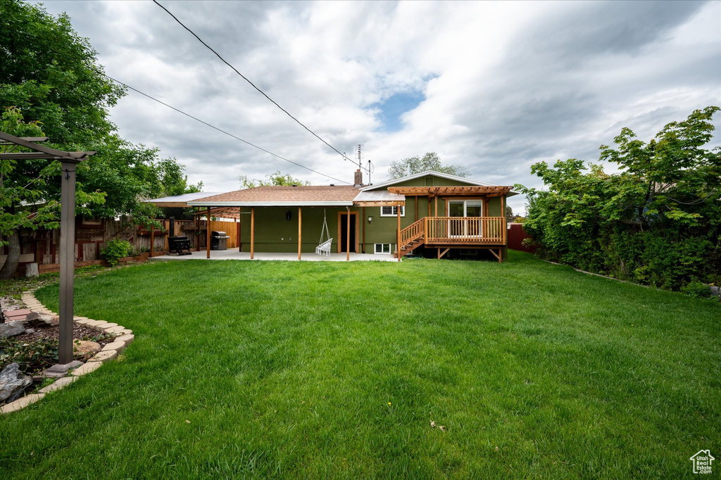 Back of house featuring a patio and a deck