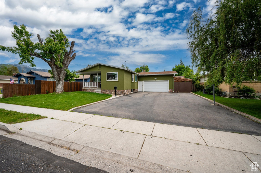 Ranch-style home featuring driveway and a garage