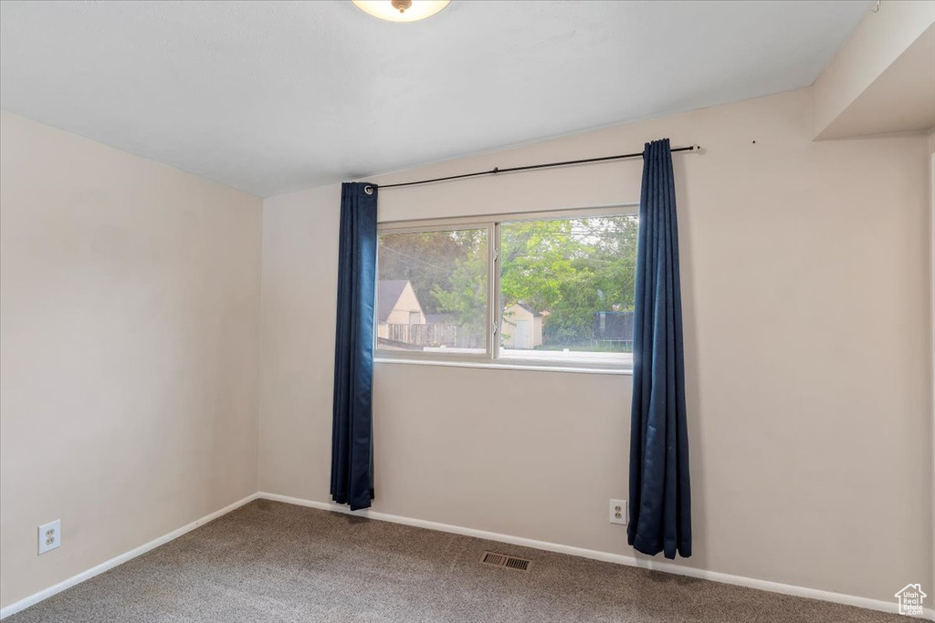 Unfurnished room featuring carpet flooring and baseboards