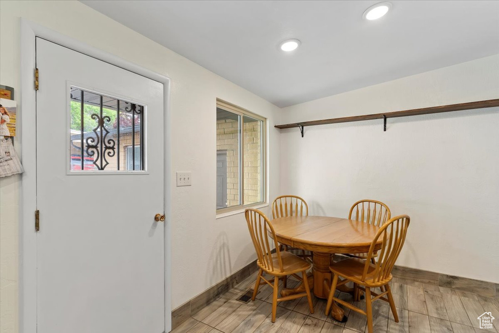 Dining room featuring baseboards, recessed lighting, and light wood-type flooring