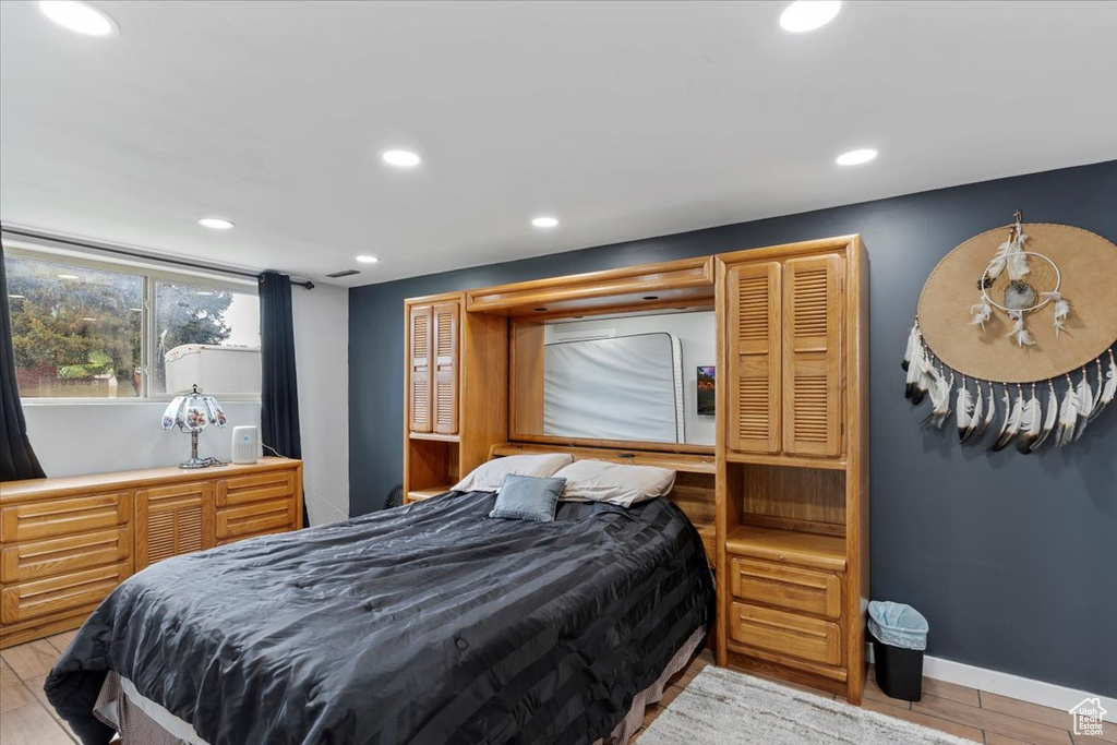 Bedroom with recessed lighting, wood finished floors, and baseboards