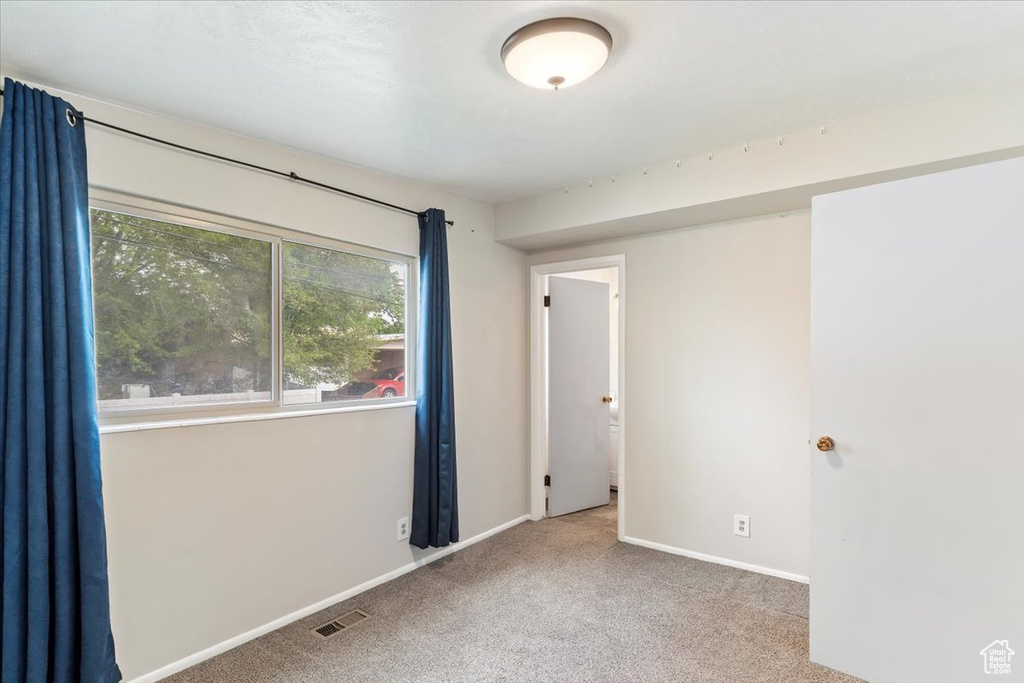 Unfurnished room with carpet and baseboards
