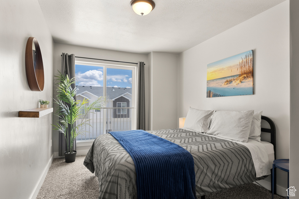 Bedroom featuring carpet and baseboards