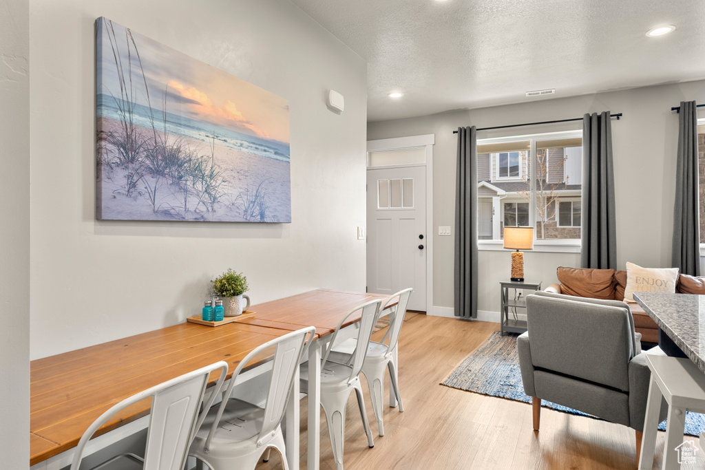 Dining space with recessed lighting, light wood-style floors, and baseboards