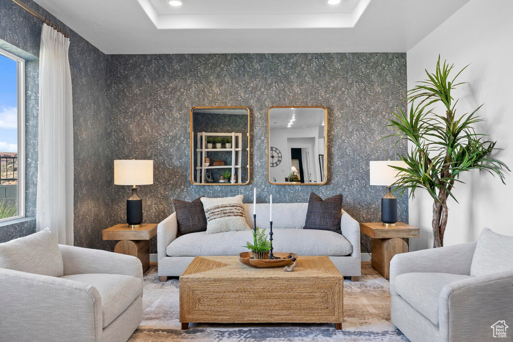 Living area with a tray ceiling and recessed lighting