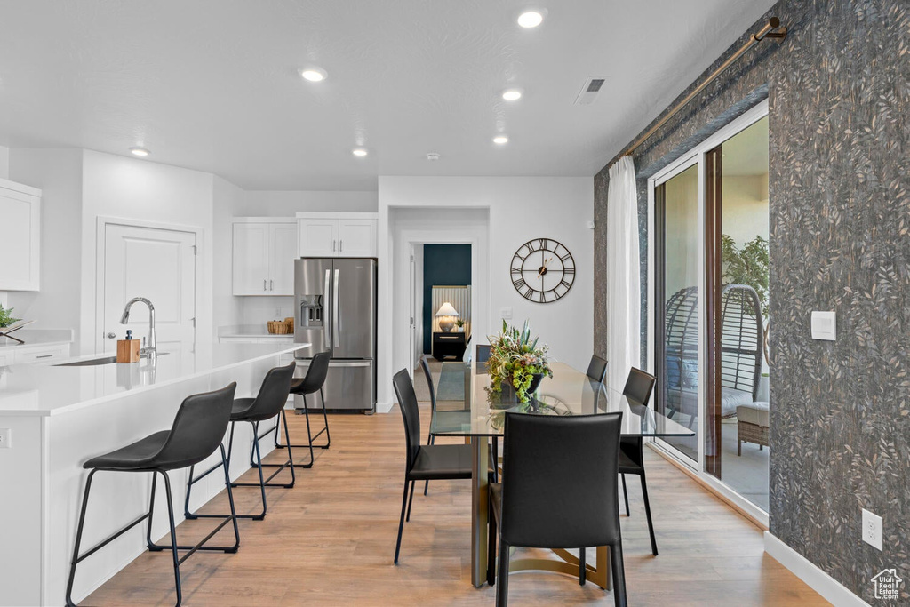 Dining area featuring recessed lighting, light wood-style flooring, and baseboards