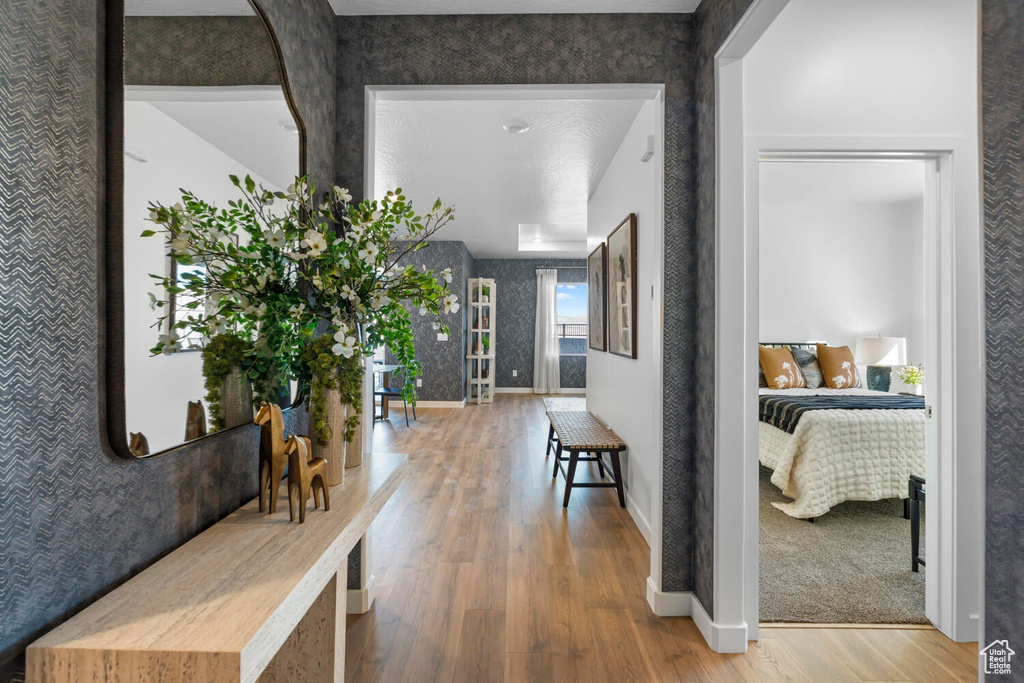 Hall with wood finished floors and baseboards