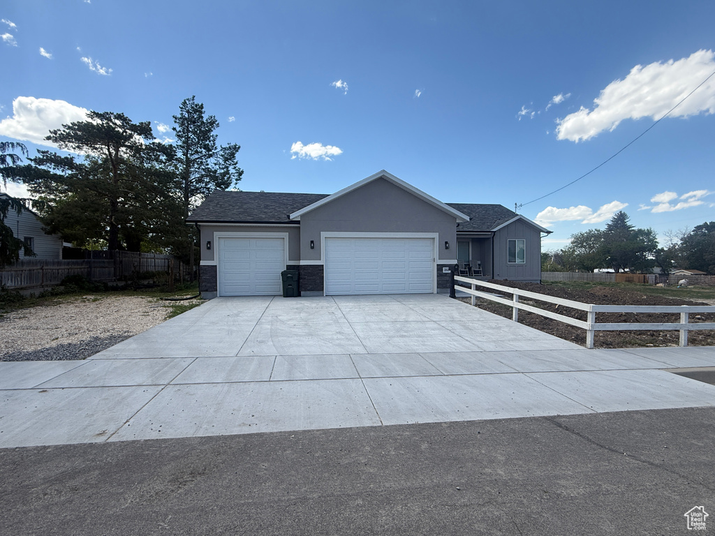 Single story home with an attached garage, concrete driveway, and stucco siding