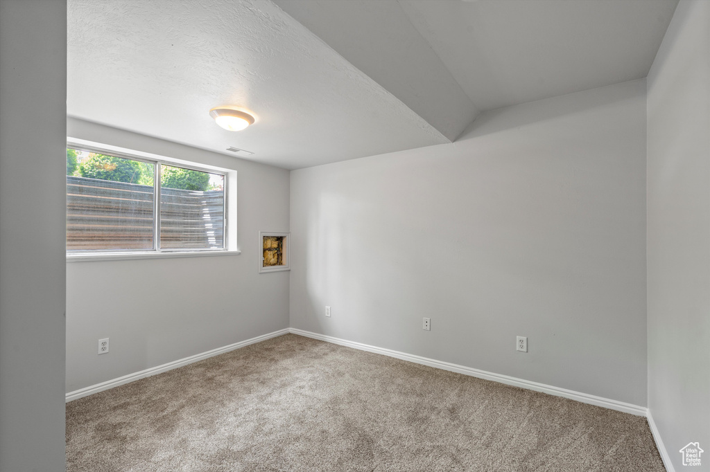Empty room with carpet and baseboards