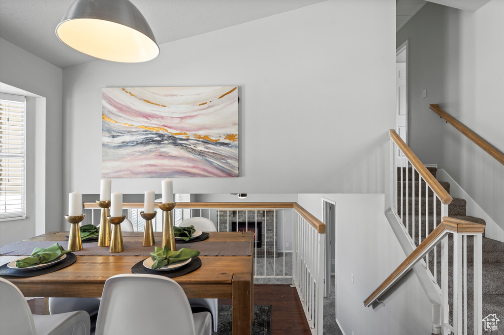 Dining area featuring healthy amount of natural light, wood finished floors, and stairs