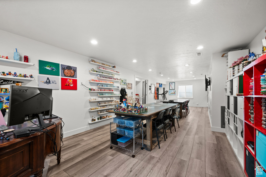 Kitchen with open shelves, light wood-style floors, recessed lighting, and baseboards