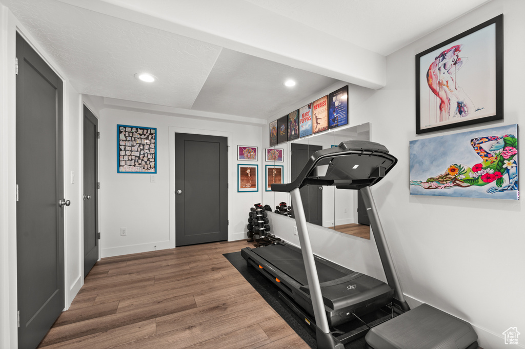 Workout room with recessed lighting, wood finished floors, and baseboards