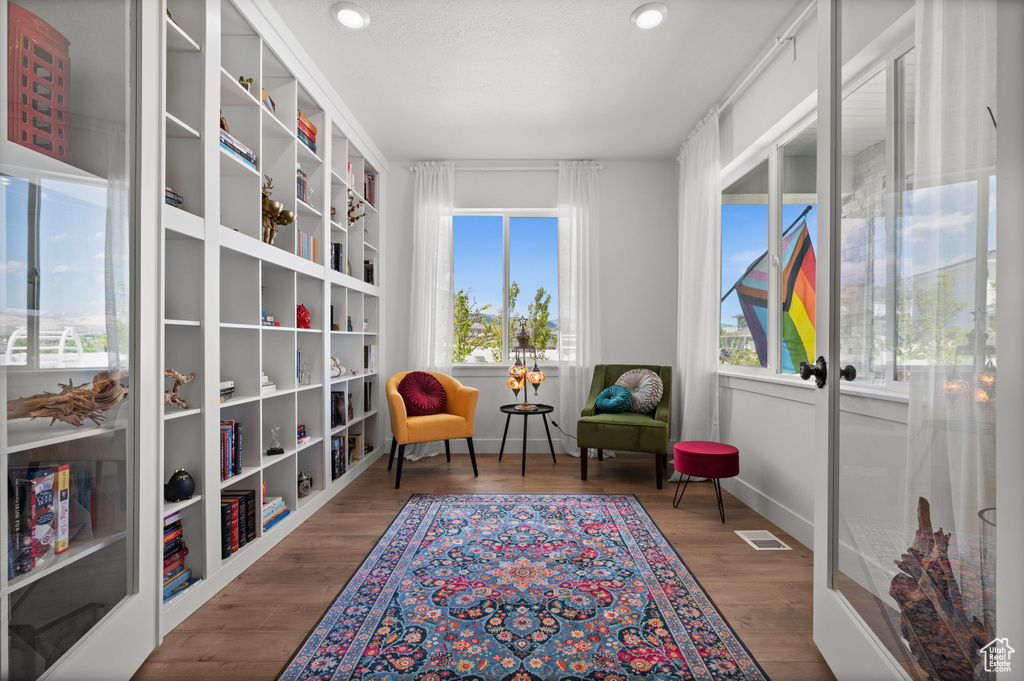 Sitting room featuring wood finished floors, recessed lighting, french doors, and baseboards